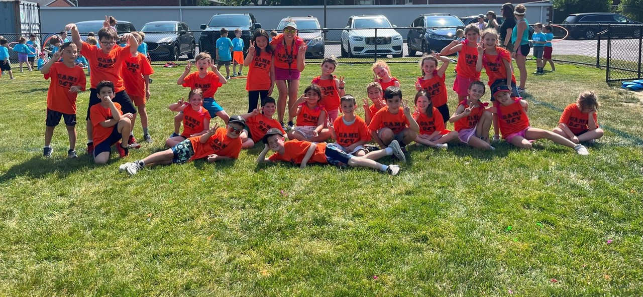 Second grade students pose outside on the field at Goldwood Games